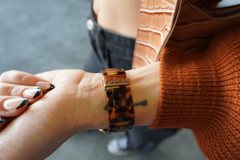 A wpmens apple watch band on a females wrist